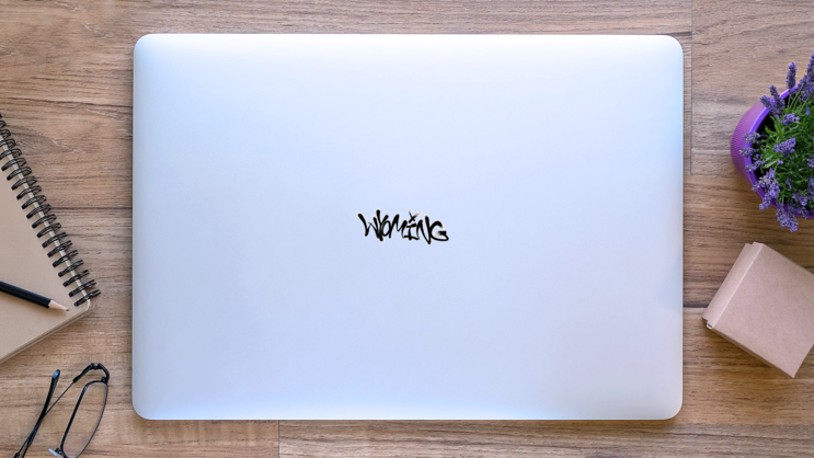 Sprayed Wyoming Font Graffiti Sticker on a Laptop (New) example