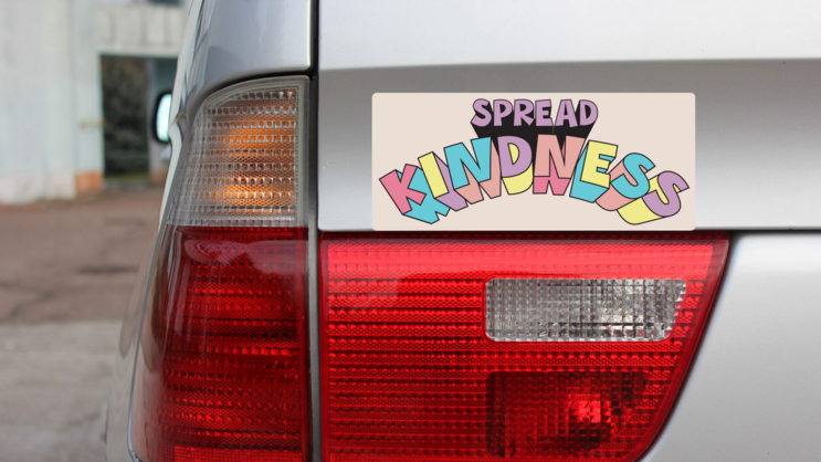 Spread Kindness Bumper Sticker on a Gold Car Rear Bumper example