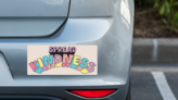 Spread Kindness Bumper Sticker on a Grey Car Bumper example
