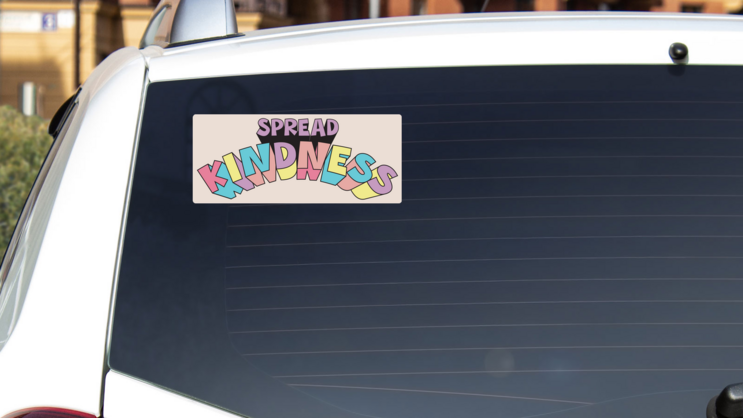 Spread Kindness Bumper Sticker on a White Car Rear Window example