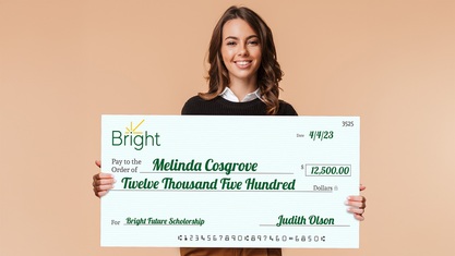 Student Holding Giant Check For Scholorship