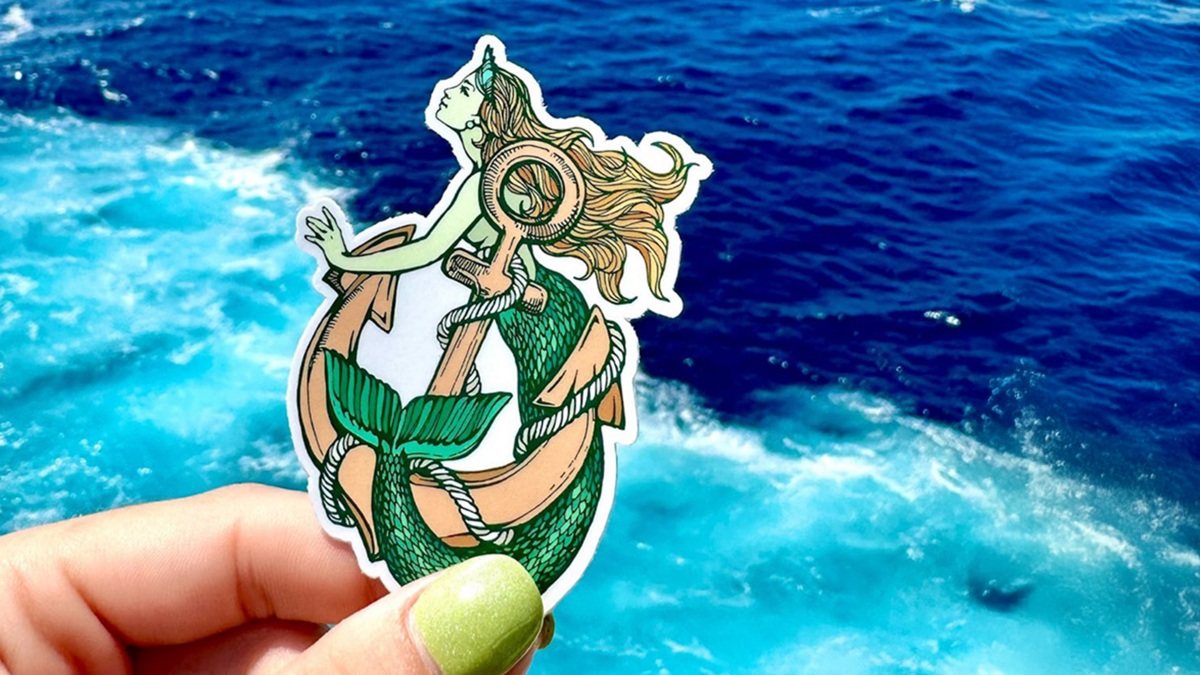 Cute Mermaid Sticker in Hand on the Beach in the Summer