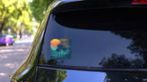 Sunset On Tropical Beach With Palm Tree Sticker on a Rear Car Window (New) example