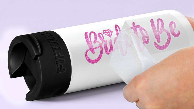 A transfer decal being applied to a reusable water bottle