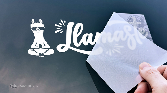 Transfer tape being removed during the application of a decal.