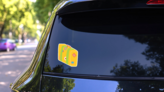 Travelers Vintage Leather Suitcase Sticker on a Rear Car Window (New) example