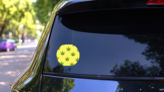 Trendy Sunlight CBD Pattern Circle Sticker on a Rear Car Window (New) example