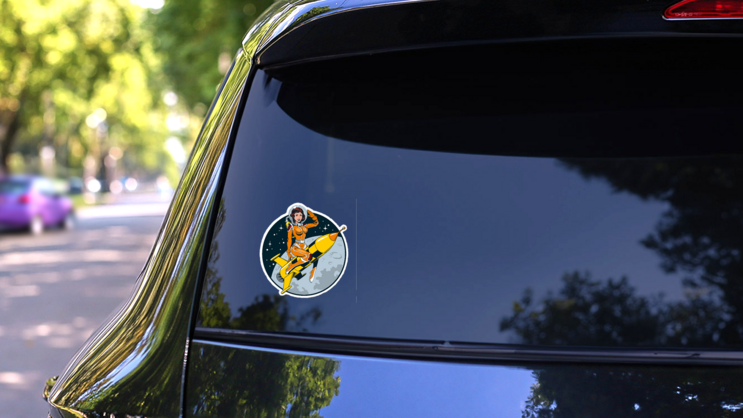 Vintage Comic Style Astronaut Woman Sticker on a Rear Car Window (New) example