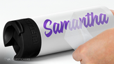 Vinyl lettering decal of a girls name being applied to a water bottle.