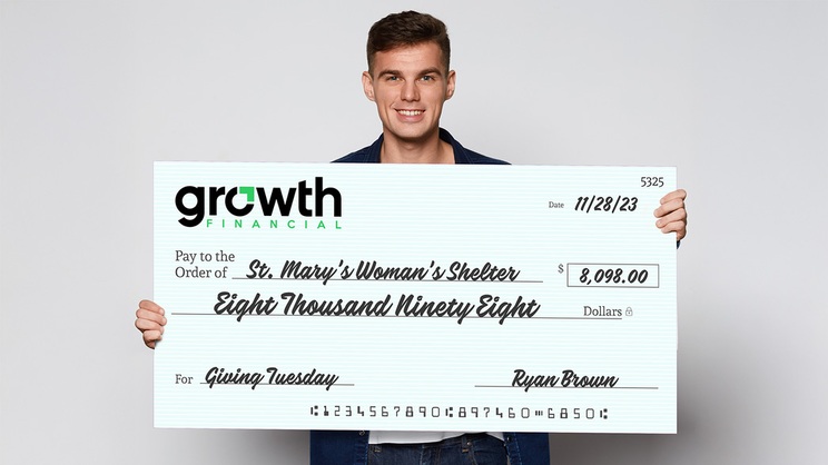 Volunteer holding Giant Donation Check