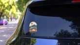 Wanderlust Outdoor Camping Sticker on a Rear Car Window (New) example