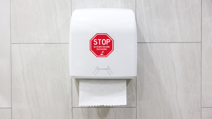 Wash Your Hands Stop Sign Sticker on a Paper Towel Holder (New) example