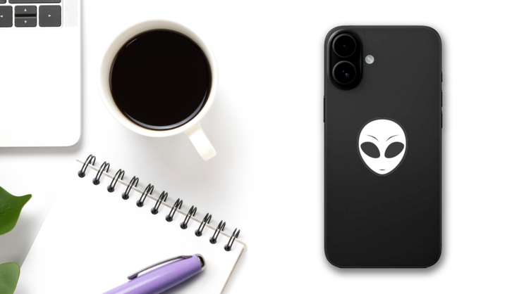 White Alien Face Sticker on a Phone (New) example