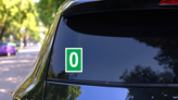 White Zero Green Background Sign Sticker on a Rear Car Window (New) example