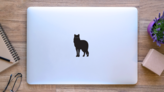 Wolf Silhouette with Beaming Eyes Sticker on a Laptop (New) example