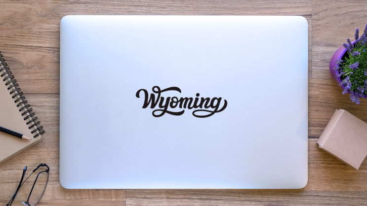 Wyoming Calligraphy Sticker on a Laptop (New) example