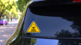 Yellow Baby on Board Sign Sticker with Happy Baby on a Rear Car Window (New) example