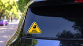 Yellow Baby on Board Sign Sticker with Stroller on a Rear Car Window (New) example