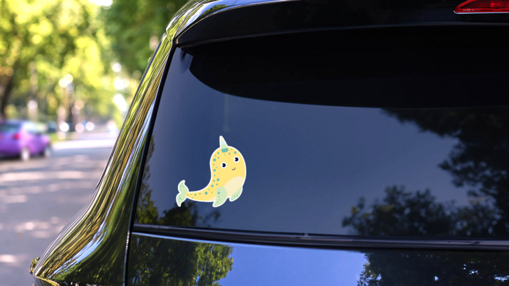 Yellow Cartoon Cute Narwhal Sticker on a Rear Car Window (New) example