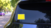 Yellow Simple Outline Map Of Wyoming Sticker on a Rear Car Window (New) example