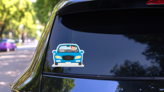 Young Man Driving Blue Car Sticker on a Rear Car Window (New) example