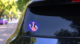 Young Woman with Soccer Ball Sticker on a Rear Car Window (New) example