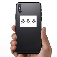 Three Skeletons Pirate Flag Sticker on a Phone example